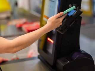 A woman pays using her smartphone at a self-checkout. 