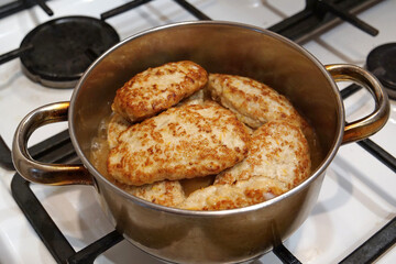 Meat cutlets are stewed in saucepan. Cooking, stewing meat. Meat patties