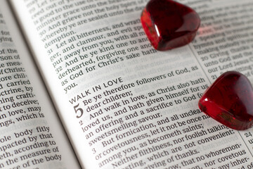 Walk in love biblical message in open holy bible book. Christian obedience and faith in God Jesus Christ concept.