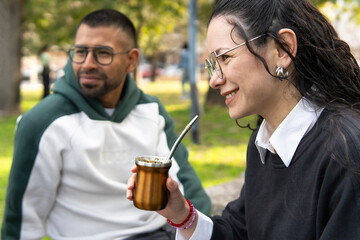 Leisure and culture: south american tradition of drinking mate in a park