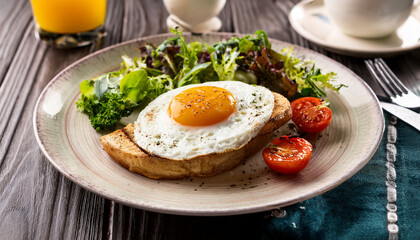 fried egg with bacon and vegetables