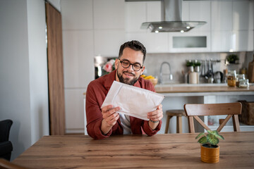 Happy man receiving package, enjoying online shopping delivery