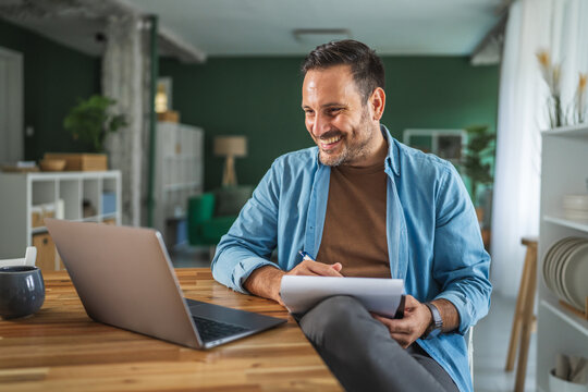 Happy man having video call working from home