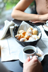 Romantic breakfast setup in cafe with sunlight and autumn garden outside the window