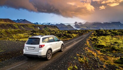 Fototapeta premium White SUV driving through volcanic landscape with moss and glaciers symbolizing exploration, resilience, and the raw beauty of Icelandic nature