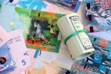 Kuwaiti dinar currency money bills and bunch of us dollar banknotes close up. The concept of economics and currency exchange