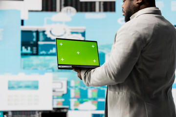 African american entrepreneur using copy space display on device, reviewing big data insights on dashboard. Young adult showcasing strategic decision making, productivity and growth.