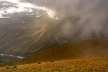Sunlight Breaking Through Storm Clouds Over The Caucasus Mountains Near Ushguli Georgia: Dramatic Landscape Of Light, Shadow And Wilderness