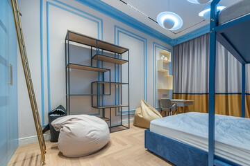 A cozy bedroom features a comfortable bed, playful bean bags, and a stylish shelving unit. A combination of blue and neutral tones creates a cheerful atmosphere perfect for relaxation.