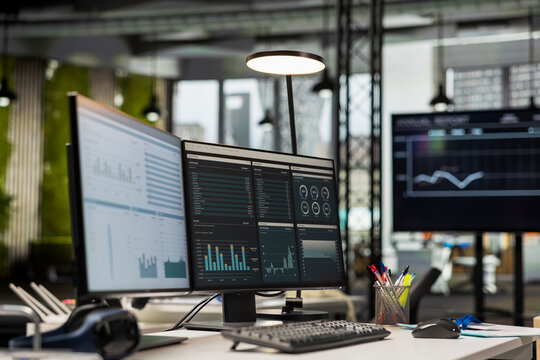 Empty corporate office features modern technology and dual monitors, analytics tools ready for business strategy and report writing to support professional growth and organizational success.