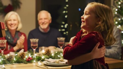 Elderly caucasian man festive sweater gives red gift to young caucasian girl red dress, embracing him joyfully. Family in festive background, warm light. Festive celebration.