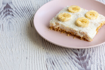 Close-Up of a Banana Coconut Cream Cake on a Pink Plate
