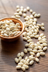 Close-Up of White Turkish-Style Beans in a Copper Cup on a Wooden Table
