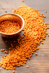 Raw Red Lentils in a Copper Bowl on a Wooden Table
