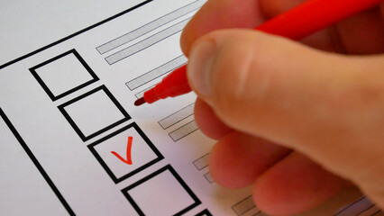 Red marker puts check next to candidate name on ballot. Democratic elections background. Electoral system strengthens citizen involvement in governance