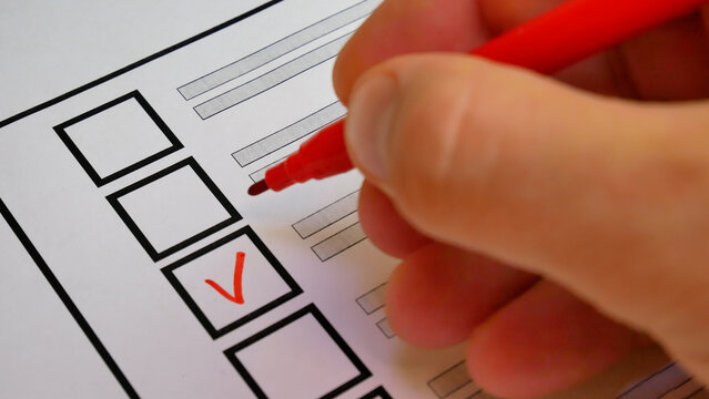 Red marker puts check next to candidate name on ballot. Democratic elections background. Electoral system strengthens citizen involvement in governance