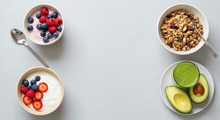 Healthy breakfast choices Yogurt with berries, granola, avocado and a green smoothie on grey