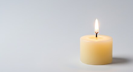 A single lit candle casting a soft shadow against a plain background, symbolizing peace and tranquility
