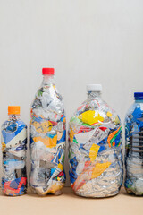 Group of four bottles of PET filled with plastic waste for upcycling and ecobricking