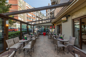 Cozy street garden café with open bar interior