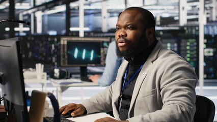 Cheerful data center admin pleased after finalizing neural network software build upgrade. Joyous...