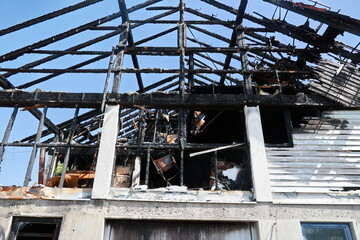 A building with a black roof and black walls