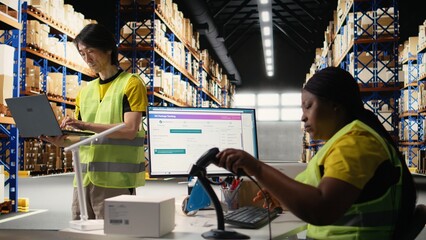 Distribution center staff managing package dispatch for a large brand, orders are processed quickly and efficiently ensuring express delivery of products packed with care. Warehouse depot. Camera A.