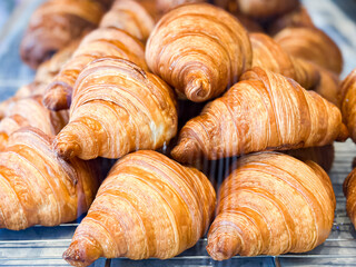 Golden Croissants on Cooling Rack in Bakery Display
