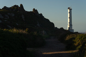Cabo (cape) Home lighthouse on the cliffs at sunset in Rias Baixas zone in Galicia coast.