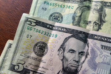 Macro shot of American five and twenty dollar bills featuring Abraham Lincoln and Andrew Jackson...