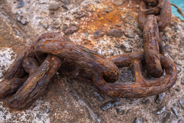 Large weathered chain showing textured rust and corrosion, symbolizing strength, age, and a secure connection