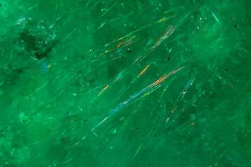 Polarized light photomicrograph of emerald inclusion field with vivid internal reflections and high magnification detail