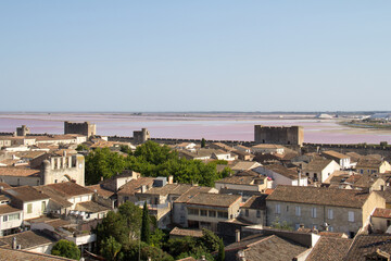 Fototapeta premium View of the ramparts, salt marshes, and medieval town of Aigues-Mortes from the Constance Tower in Aigues-Mortes Camargue France