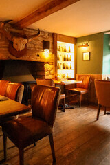 Rustic english pub creating a warm atmosphere, cozy seating providing comfort for a relaxed dining experience