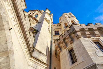Majestic stone castle facade against clear blue sky