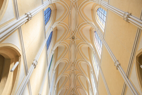 Gothic cathedral ceiling with stained glass windows and architectural details