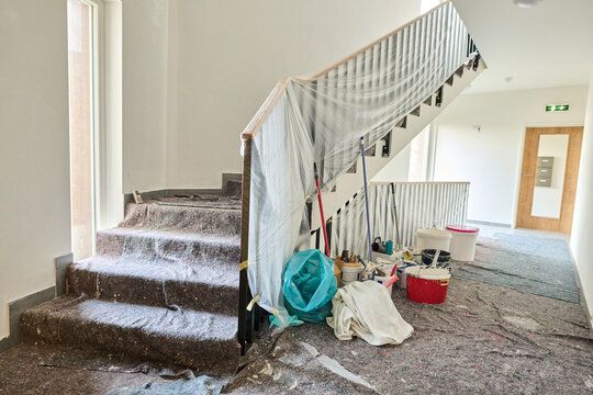 Stairwell covered for renovation with tools and ladder