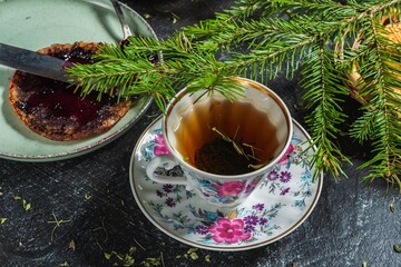 Christmas mood - spruce branch. Pancakes with jam - food and drink on a dark background
