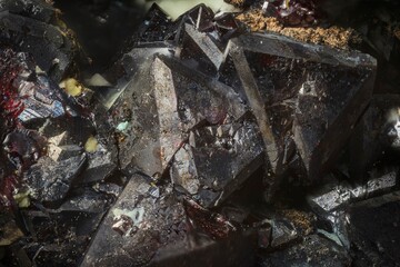 Mineral Cuprite (red copper ore) and silver crystals. Microphotography with high magnification- photo scale 10X