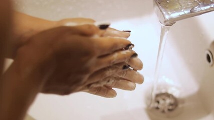 Demonstration of washing hands thoroughly with soap and water, showcasing hygiene practices for infection prevention