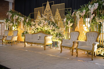 Elegant wedding reception setting with ornate gold accents and plush seating arrangements