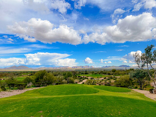 Scenic Desert Golf Course with Mountain View under Blue Sky