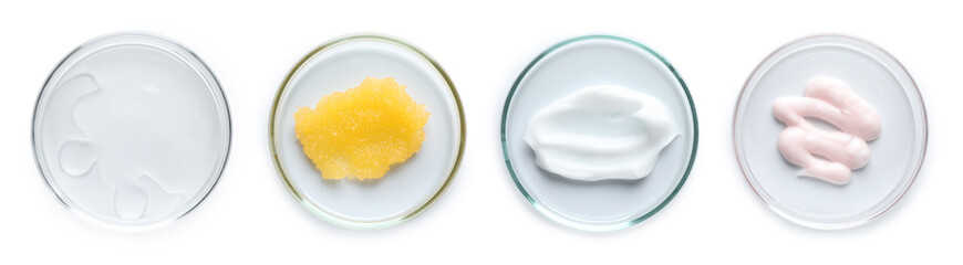 Petri dishes with cosmetic products on white background, top view
