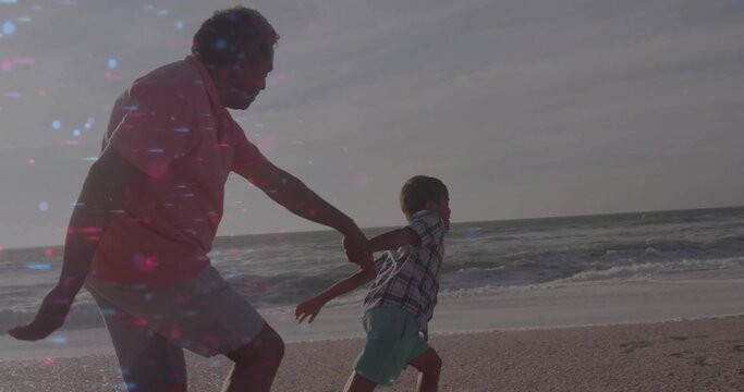 Running grandfather and grandchild sprinting along sandy shoreline, with waves and lens flares - Powered by Adobe