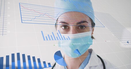 Doctor analyzing digital data overlays at hospital, wearing lab coat, cap, mask, stethoscope