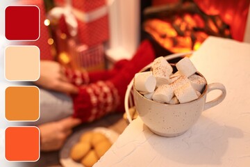 Cup of hot chocolate with marshmallows on table in room on Christmas eve. Different color patterns