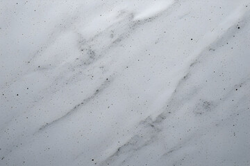 Clean, bright white abstract texture background with soft grey marbling and diagonal flow, densely covered in small black speckles, resembling speckled marble, foam, or granite countertop material.