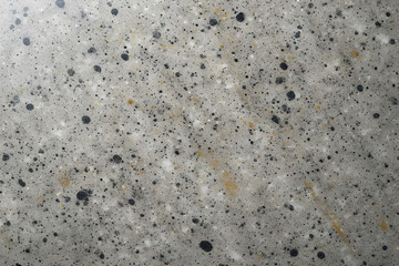 Trio of abstract speckled textures: warm beige foam with rust and brown spots, cool gray foam with dark blue-black specks, and grey quartz composite with black and gold flakes, perfect for surfaces.