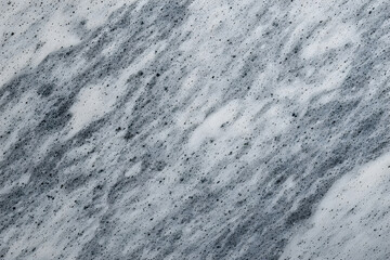 Collection of four abstract speckled stone and foam textures: bright white marble with gold and grey streaks, dark black quartz composite, and two dynamic gray and white bubbly surfaces.