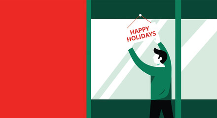 Man in green sweater hanging happy holidays sign on window of shop during the christmas season, spreading cheer and festive spirit.